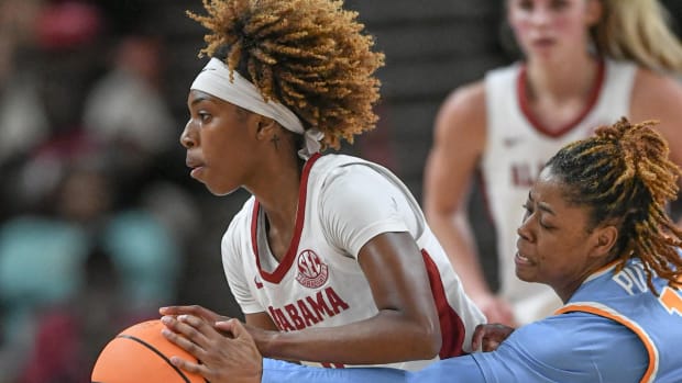 Tennessee guard Jasmine Powell (15) reaches in for a ball held by Alabama guard Loyal McQueen (0) during the second quarter of the SEC Women's Basketball Tournament game at the Bon Secours Wellness Arena in Greenville, S.C. Friday, March 8, 2024.